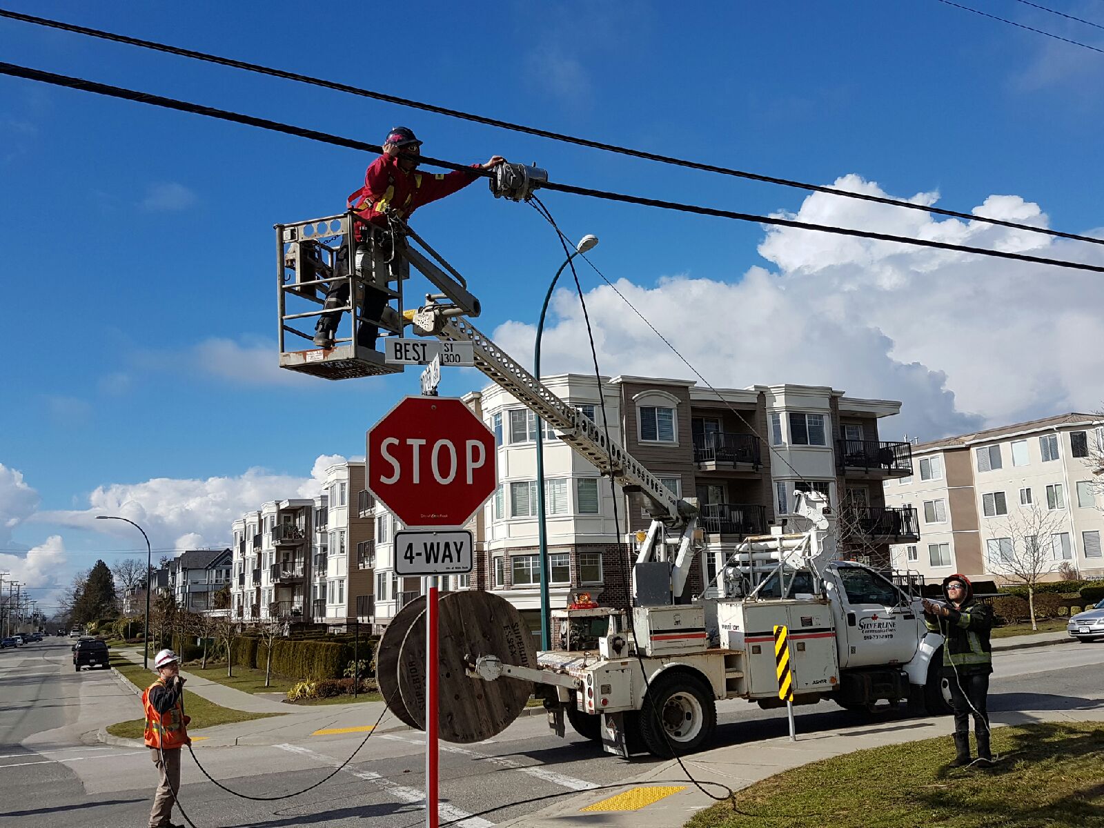 linemen in bucket truck working on fiber overlash