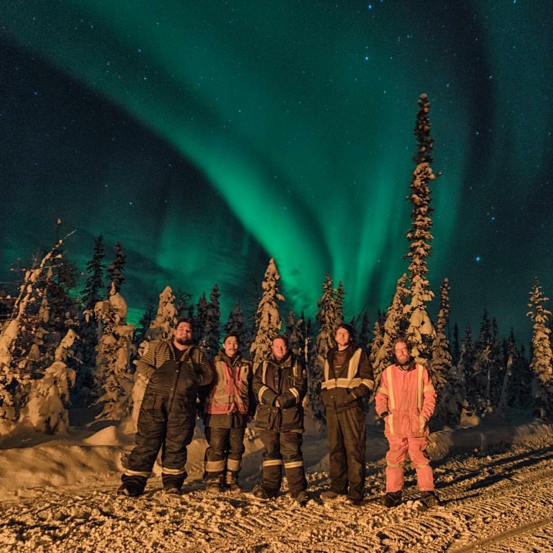 crew in front of the northern lights in the NorthWest
