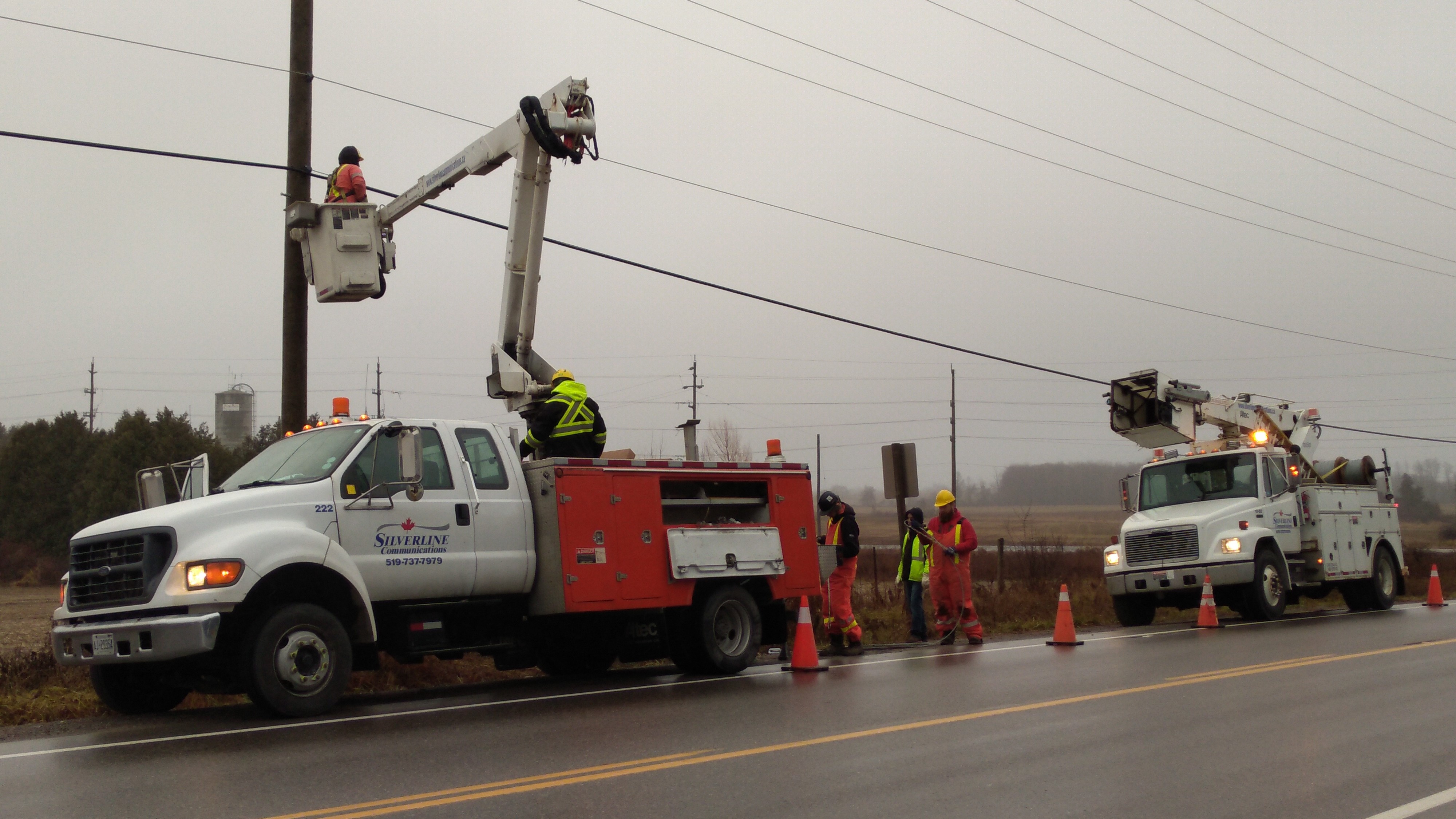 linemen in bucket truck working on fibre