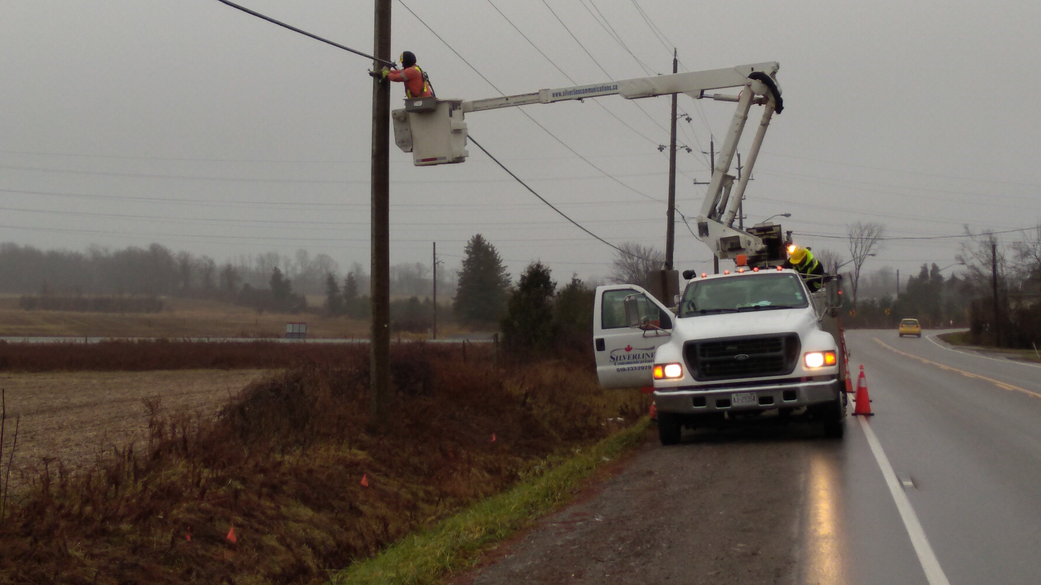 linemen in bucket truck working on fibre